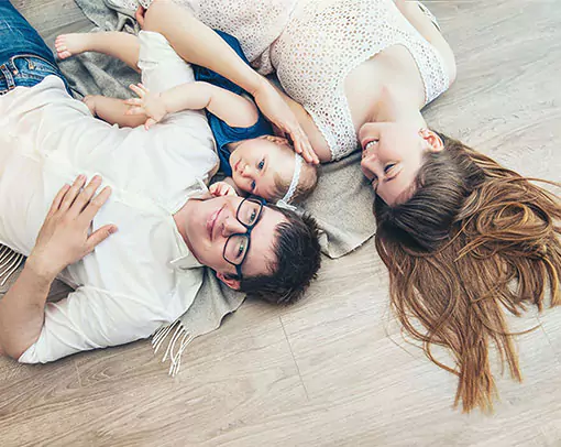 Family lying on floor | Crest Flooring